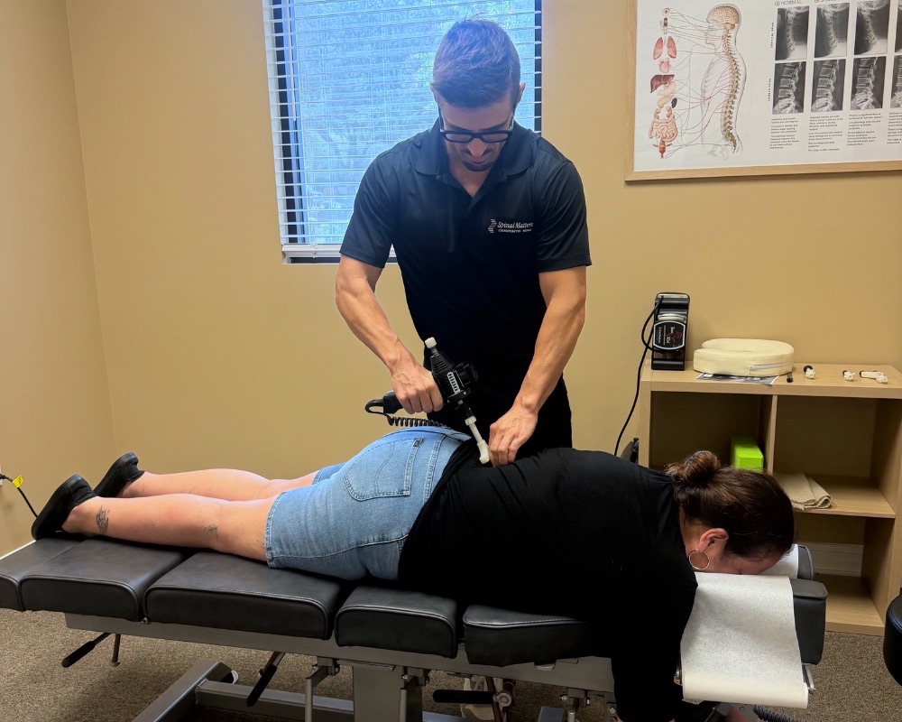 Dr. Butler adjusting a patient's lower back